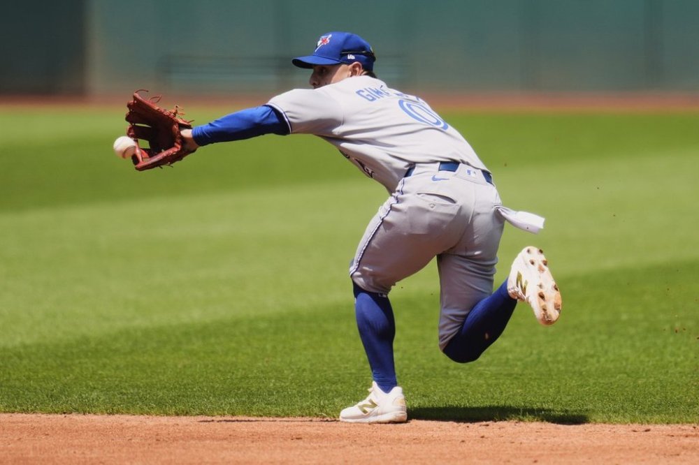 Toronto Blue Jays second baseman Andres Gimenez fields a ground ball in the third inning of a Major League Baseball game in Cleveland on Thursday, June 26, 2025. (AP Photo/Sue Ogrocki)