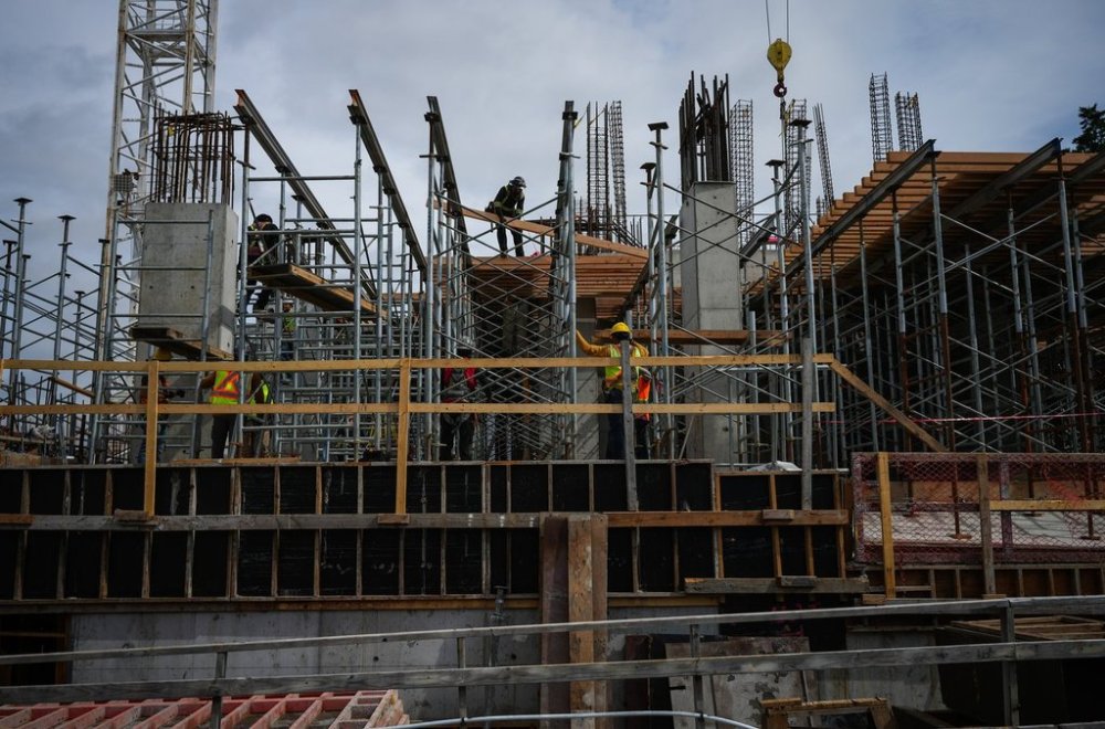 Construction workers work at the site of a condo tower under construction, in Delta, B.C., on Wednesday, July 2, 2025. THE CANADIAN PRESS/Darryl Dyck