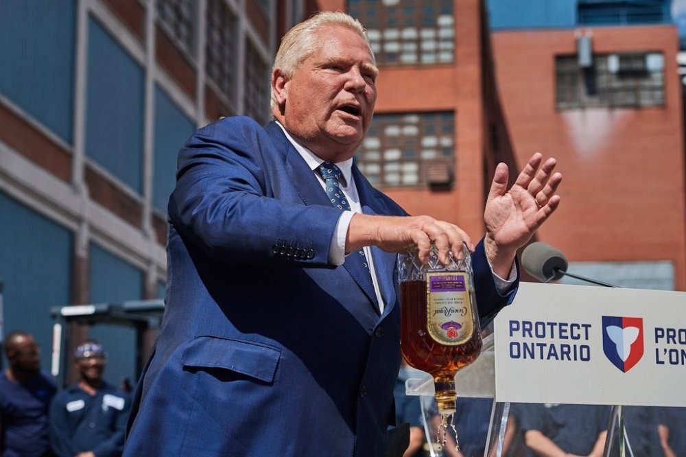 Ontario Premier Doug Ford empties a Crown Royal bottle of whisky at a press conference in Kitchener, Ont., on Tuesday, Sept. 2, 2025. Ford criticized the popular whisky's parent company, Diageo, for their plan to close one of their Ontario bottling plants in the coming months. THE CANADIAN PRESS/Sammy Kogan