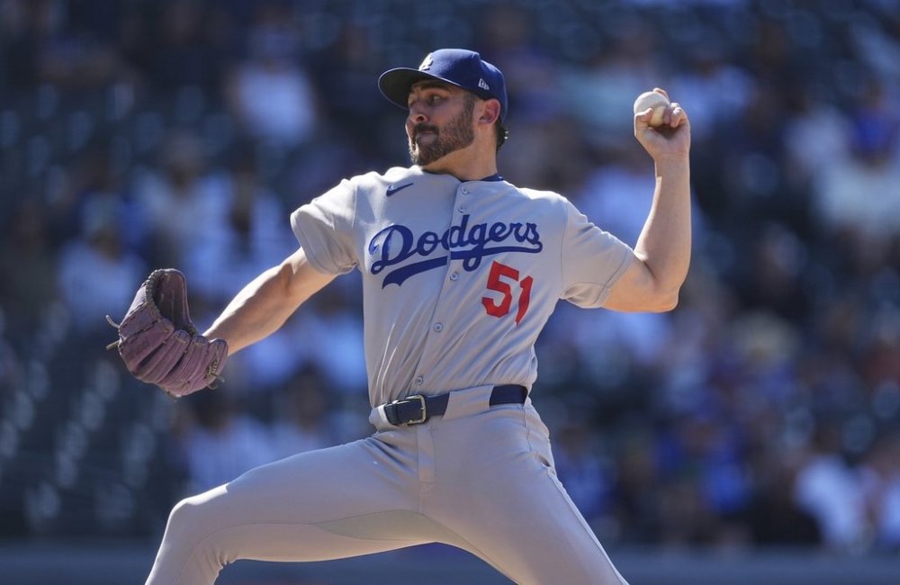 Los Angeles Dodgers relief pitcher Alex Vesia works against the Colorado Rockies in the ninth inning of a baseball game Thursday, Aug. 21, 2025, in Denver. (AP Photo/David Zalubowski)
