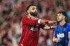 Liverpool's Mohamed Salah celebrates scoring their side's fourth goal of the game with a tribute to teammate Diogo Jota during the English Premier League soccer match between Liverpool and Bournemouth at Anfield, Liverpool, England, Friday Aug. 15, 2025. (Peter Byrne/PA via AP)