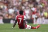 Arsenal's Bukayo Saka sits on the ground after getting injured during the English Premier League soccer match between Arsenal and Leeds United at Emirates stadium in London, England, Saturday, Aug. 23, 2025. (AP Photo/Ian Walton)