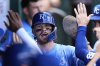 Kansas City Royals' Bobby Witt Jr. celebrates in the dugout after scoring on an RBI single hit by Salvador Perez during the third inning of a baseball game against the Texas Rangers, Thursday, Aug. 21, 2025, in Kansas City, Mo. (AP Photo/Charlie Riedel)