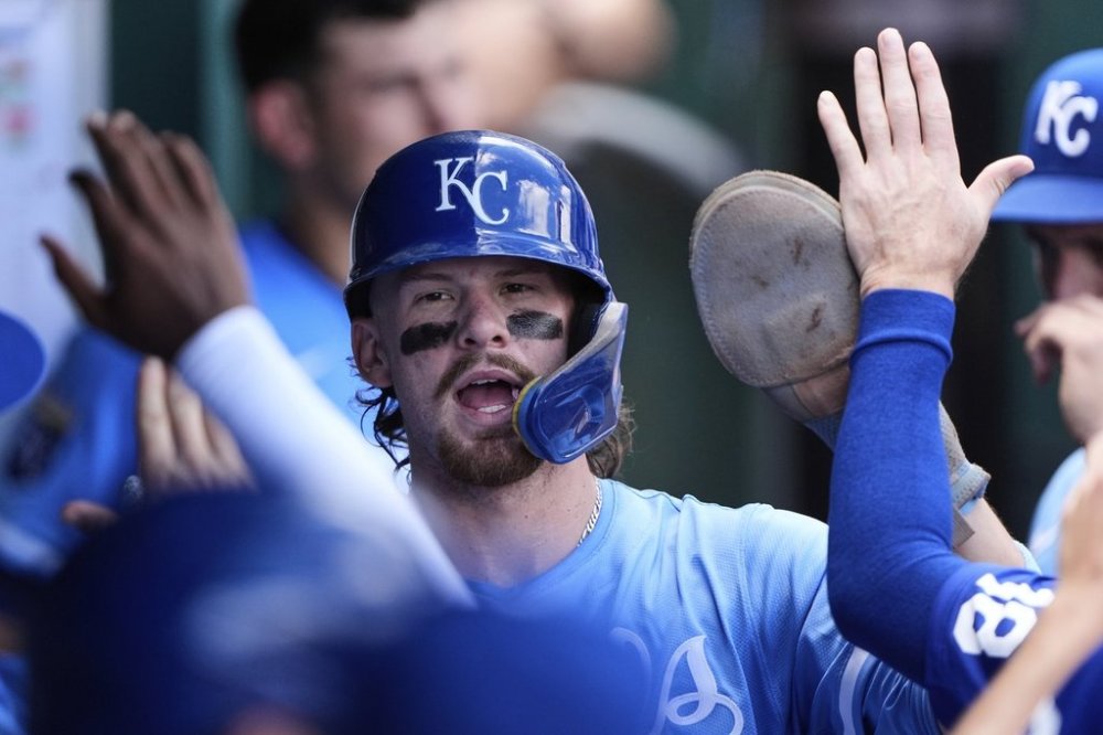 Kansas City Royals' Bobby Witt Jr. celebrates in the dugout after scoring on an RBI single hit by Salvador Perez during the third inning of a baseball game against the Texas Rangers, Thursday, Aug. 21, 2025, in Kansas City, Mo. (AP Photo/Charlie Riedel)