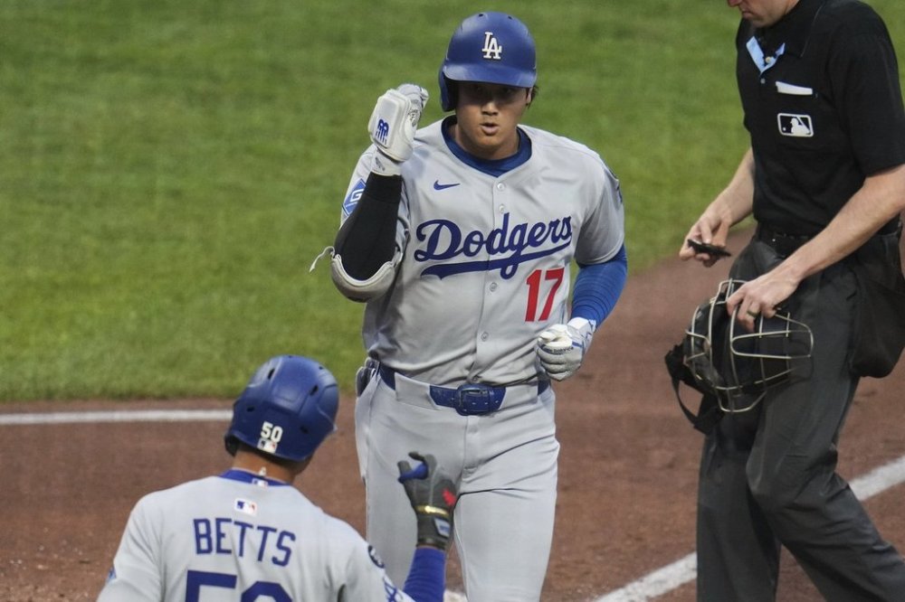 Los Angeles Dodgers' Shohei Ohtani (17) returns to the dugout after after hitting a solo home run off Pittsburgh Pirates pitcher Bubba Chandler during the third inning of a baseball game in Pittsburgh, Tuesday, Sept. 2, 2025. (AP Photo/Gene J. Puskar)