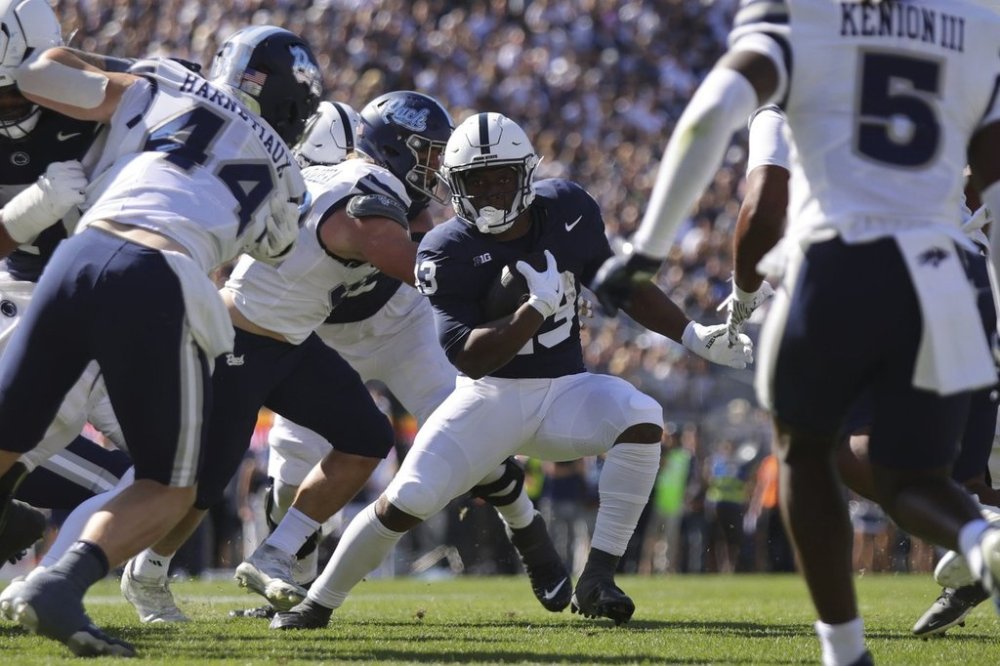 Penn State running back Kaytron Allen (13) runs the ball against Nevada during the first quarter of an NCAA college football game, Saturday, Aug. 30, 2025, in State College, Pa. (AP Photo/Jared Freed)