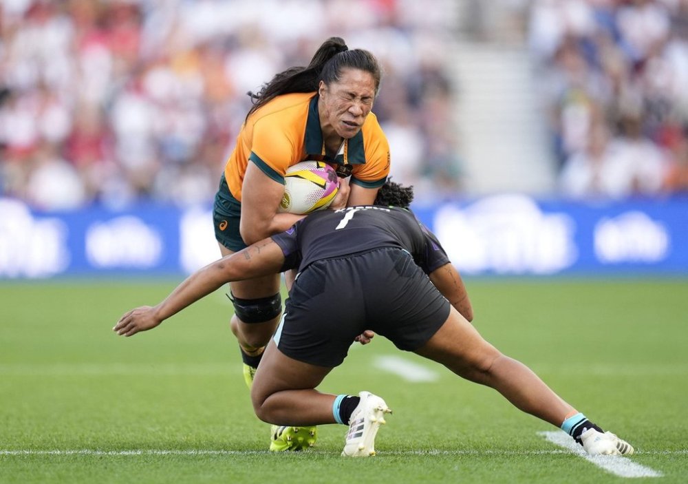 England's Sadia Kabeya tackles Australia's Siokapesi Palu during the Women's Rugby World Cup 2025 Pool A match between England and Australia at the Brighton and Hove Albion Stadium, in Brighton and Hove, England, Saturday, Sept. 6, 2025. (Andrew Matthews/PA via AP)