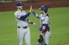 Texas Rangers' Jonah Heim, left, and Kyle Higashioka celebrate after their baseball game against the Kansas City Royals, Wednesday, Aug. 20, 2025, in Kansas City, Mo. (AP Photo/Charlie Riedel)