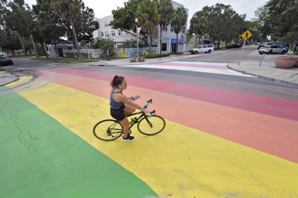 A cyclist crosses a rainbow-painted street mural Wednesday, Aug. 27, 2025, in St. Petersburg, Fla. (AP Photo/Chris O'Meara)