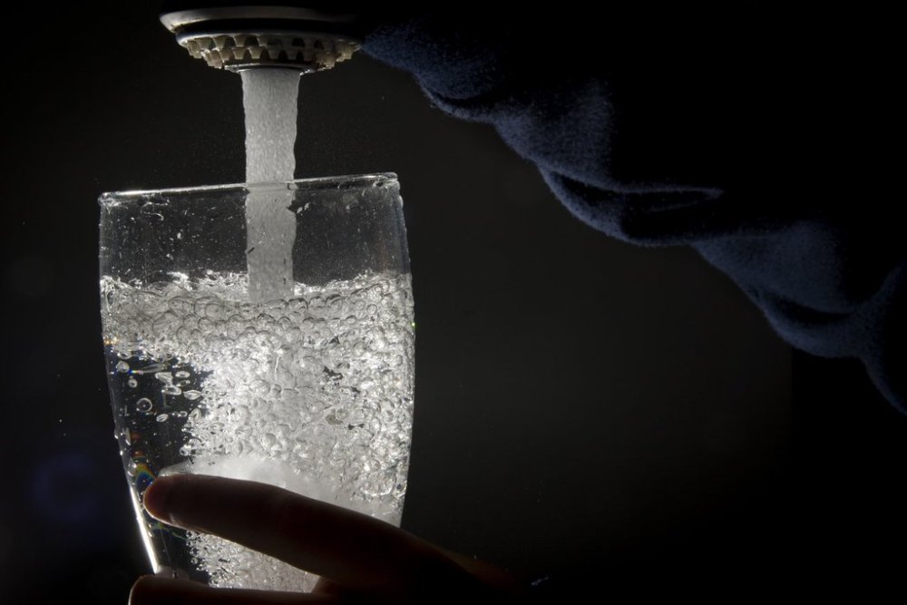 Drinking water is poured into a glass from a faucet in North Vancouver, July, 30, 2019. THE CANADIAN PRESS/Jonathan Hayward