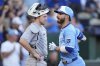 Kansas City Royals' John Rave crosses the plate past Chicago White Sox catcher Kyle Teel after hitting a solo home run during the third inning of a baseball game Saturday, Aug. 16, 2025, in Kansas City, Mo. (AP Photo/Charlie Riedel)