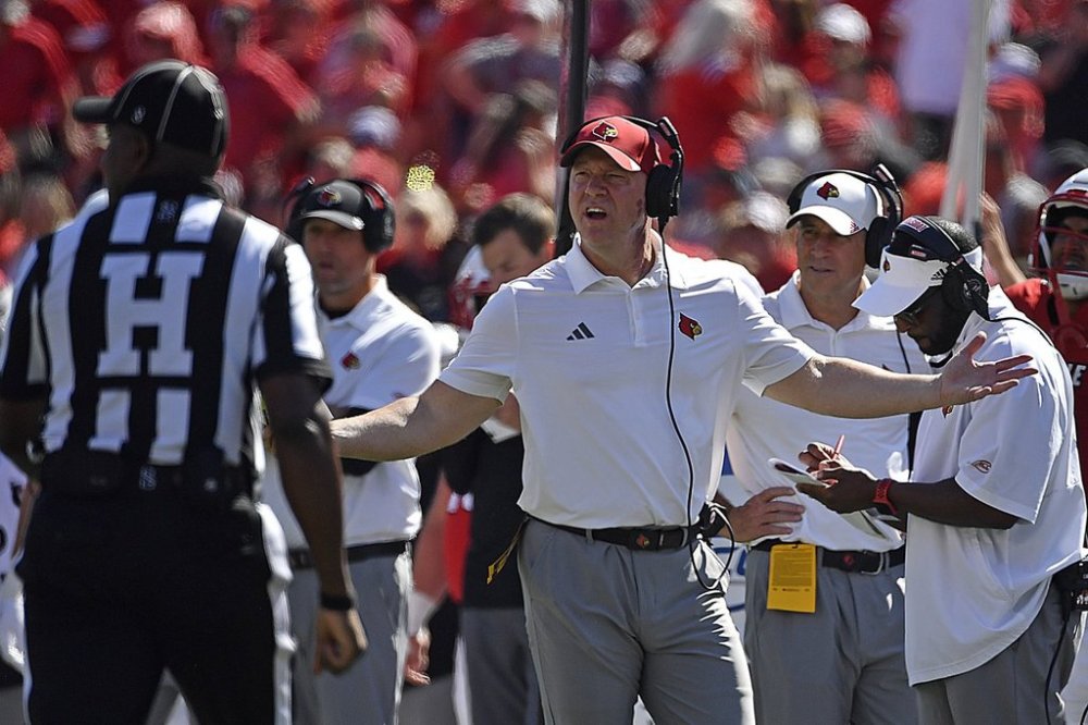 Louisville head coach Jeff Brohm argues with a game official during the first half of an NCAA college football game against Eastern Kentucky, in Louisville, Ky., Saturday, Aug. 30, 2025. (AP Photo/Timothy D. Easley)