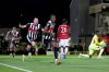Grimsby Town's Tyrell Warren, center, celebrates scoring their side's second goal during an English League Cup second round soccer match against Manchester United, Wednesday, Aug. 27, 2025, at Hill Blundell Park in Grimsby, England. (Nigel French/PA via AP)
