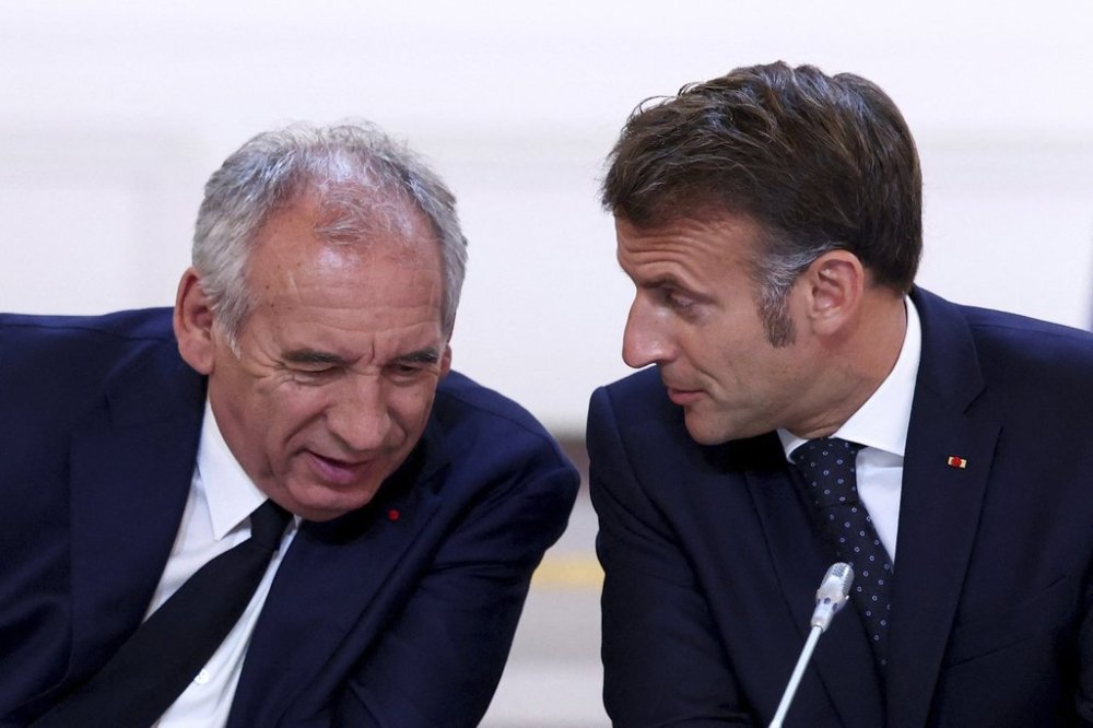 FILE -French President Emmanuel Macron, left, and Prime Minister Francois Bayrou attend a meeting with New Caledonia's elected officials and state representatives who have concluded a historic agreement allowing the creation of a
