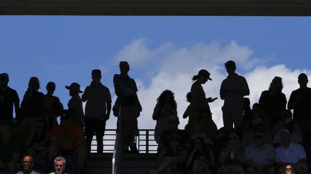 Spectators watch play between Victoria Mboko, of Canada, and Barbora Krejcikova, of the Czech Republic, during the first round of the US Open tennis championships, Monday, Aug. 25, 2025, in New York. (AP Photo/Kirsty Wigglesworth)