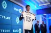 New Vancouver Whitecaps player Thomas Muller poses with his jersey during a news conference in Vancouver, on Thursday, Aug. 14, 2025. THE CANADIAN PRESS/Darryl Dyck