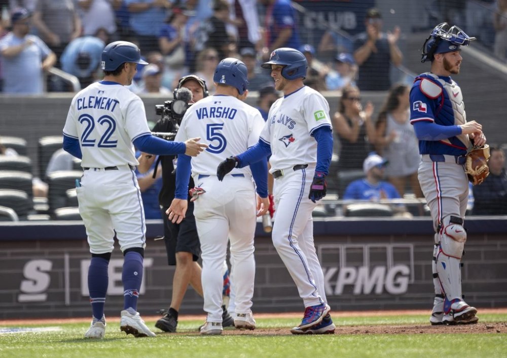 Toronto Blue Jays' Myles Straw (3) celebrates his home run with teammates Ernie Clement (22) and Daulton Varsho (5) during the second inning against the Texas Rangers in Toronto, Saturday, Aug. 16, 2025. THE CANADIAN PRESS/Tara Walton