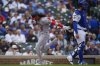 Washington Nationals' CJ Abrams (5) runs by Chicago Cubs catcher Carson Kelly (15) to score on a single from Washington Nationals catcher Jorge Alfaro (44) during the first inning of a baseball game Saturday, Sept. 6, 2025, in Chicago. (AP Photo/Erin Hooley)