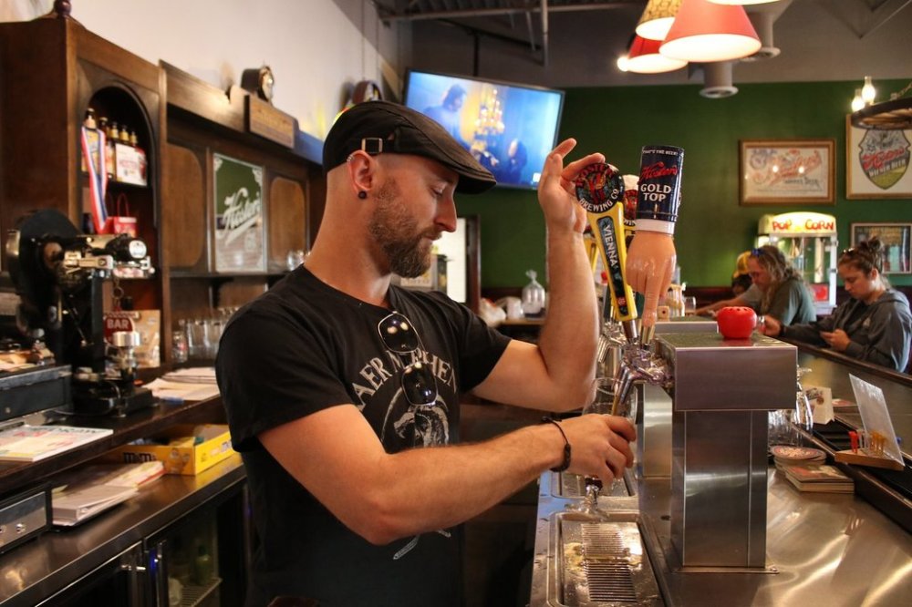 Ian Hansford pours a beer at Hoster Brewing in Columbus on Wednesday, Aug. 13, 2025. THE CANADIAN PRESS/Kelly Geraldine Malone