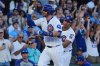 Chicago Cubs' Carson Kelly, left, is congratulated by third base coach Quintin Berry, right, after hitting a two-run home run during the eighth inning of a baseball game against the Atlanta Braves in Chicago, Monday, Sept. 1, 2025. (AP Photo/Nam Y. Huh)