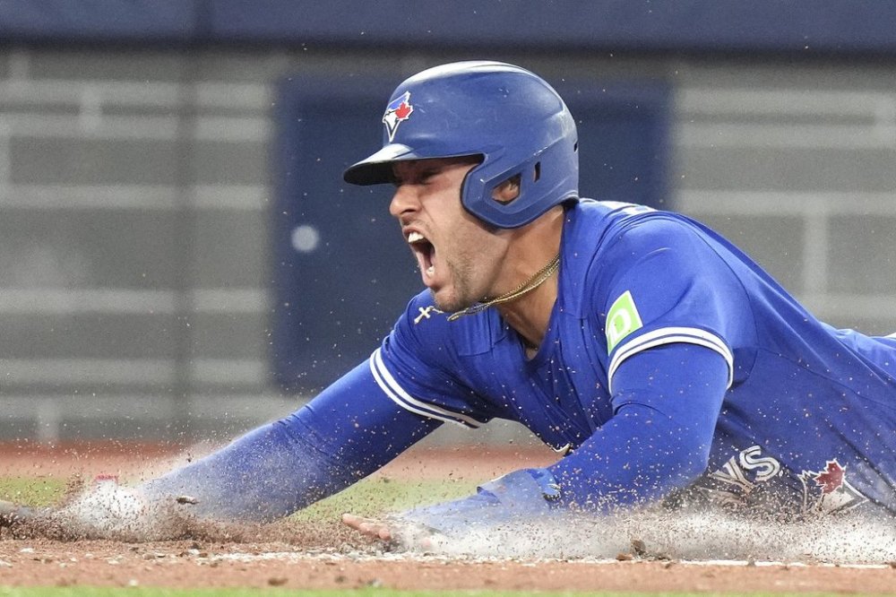 Toronto Blue Jays' George Springer (4) reacts after scoring a run against the Minnesota Twins during third inning MLB baseball action in Toronto on Wednesday, August 27, 2025. THE CANADIAN PRESS/Chris Young