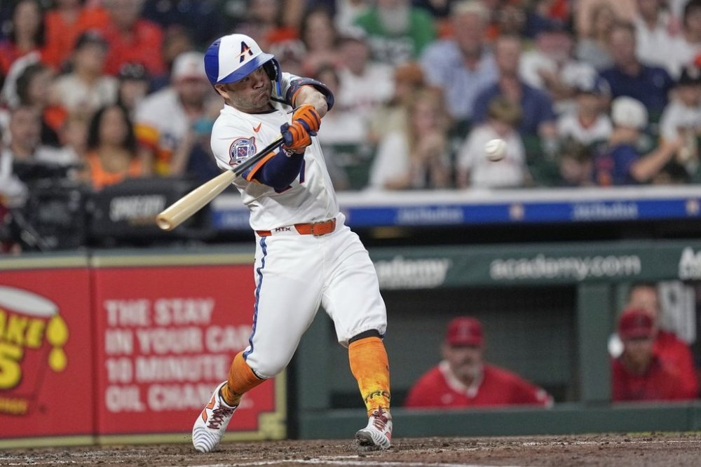 Houston Astros' Jose Altuve hits a RBI double against the Los Angeles Angels during the third inning of a baseball game Monday, Sept. 1, 2025, in Houston. (AP Photo/David J. Phillip)