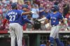 Toronto Blue Jays' Bo Bichette, far right, is congratulated by George Springer, centre, and Vladimir Guerrero Jr. (27) after hitting a three-run home run in the second inning of a baseball game against the Cincinnati Reds, Tuesday, Sept. 2, 2025, in Cincinnati. (AP Photo/Kareem Elgazzar)