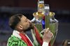FILE - PSG's goalkeeper Gianluigi Donnarumma kisses the trophy after the Champions League final soccer match between Paris Saint-Germain and Inter Milan at the Allianz Arena in Munich, Germany, Saturday, May 31, 2025. (AP Photo/Matthias Schrader, File)