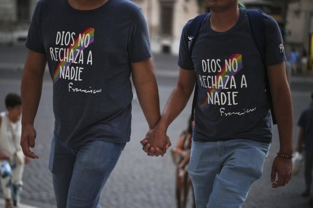 Members of the LGBTQ+ community, who's t-shirts read