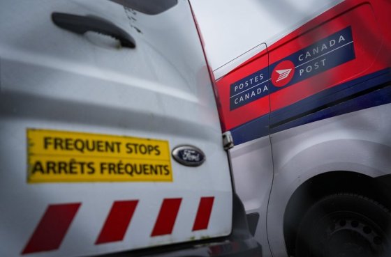Canada Post vehicles at a delivery depot in Vancouver, B.C. (Darryl Dyck / The Canadian Press files)