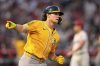 Athletics' Colby Thomas gestures toward his dugout as he heads to first for a three-run home run as Los Angeles Angels pitcher Yusei Kikuchi stands on the mound during the second inning of a baseball game Saturday, Sept. 6, 2025, in Anaheim, Calif. (AP Photo/Mark J. Terrill)