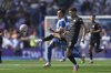 Brighton's Kaoru Mitoma, centre, challenges for the ball with Manchester City's John Stones during the English Premier League soccer match between Brighton and Hove Albion and Manchester City at the Falmer stadium in Brighton, England, Sunday, Aug. 31, 2025. (AP Photo/Ian Walton)
