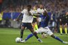 Oviedo's Kwasi Sibo, right, and Real Madrid's Rodrygo fight for the ball during a Spanish La Liga soccer match between Real Oviedo and Real Madrid at Carlos Tartiere stadium in Oviedo, Spain, Sunday, Aug. 24, 2025. (AP Photo/Miguel Oses)