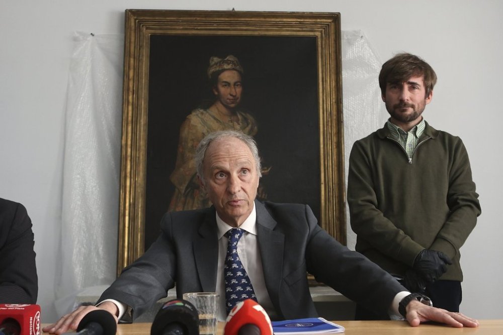 Prosecutor Daniel Adlers gives a press conference in front of Giuseppe Ghislandi's 18th-century painting