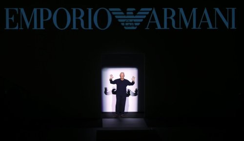 FILE - Fashion designer Giorgio Armani acknowledges the applause after presenting his Emporio Armani men's Fall-Winter 2017-2018 collection, part of the Milan Fashion Week, unveiled in Milan, Italy, Saturday, Jan. 14, 2017. (AP Photo/Antonio Calanni, File)