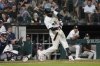 Chicago White Sox' Luis Robert Jr. hits a home run against the Minnesota Twins during the eighth inning of a baseball game Saturday, August 23, 2025, in Chicago. (AP Photo/David Banks)