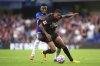 Chelsea's Dario Eussugo, left, and Bayer Leverkusen's Amine Adli in action during the pre-season friendly match between Chelsea and Bayer 04 Leverkusen at Stamford Bridge, London, Friday Aug. 8, 2025. (Adam Davy/PA via AP)
