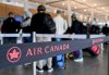 People wait to check-in at Trudeau airport in Montreal, Friday, Jan. 3, 2025, on the day Air Canada implements carry-on-fees for basic fare tickets. THE CANADIAN PRESS/Graham Hughes.