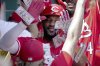 Teammates shower Cincinnati Reds' Miguel Andujar with play money in the dugout after his three-run home run during the third inning of a baseball game against the Pittsburgh Pirates, Sunday, Aug. 10, 2025, in Pittsburgh. (AP Photo/Matt Freed)