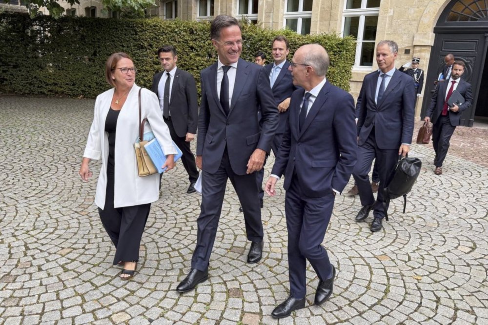 NATO Secretary General Mark Rutte, center, walks with Luxembourg's Prime Minister Luc Frieden, center right, and Luxembourg's Defense Minister Yuriko Backes, center left, prior to a meeting in Luxembourg, Tuesday, Sept. 2, 2025. (AP Photo/Sam McNeil)
