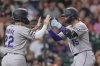Colorado Rockies' Hunter Goodman (15) celebrates with Mickey Moniak (22) after both scored on Goodman's home run against the Houston Astros during the third inning of a baseball game Tuesday, Aug. 26, 2025, in Houston. (AP Photo/David J. Phillip)