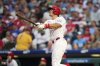 Philadelphia Phillies' J.T. Realmuto watches after hitting a home run against Seattle Mariners pitcher Logan Gilbert during the second inning of a baseball game Monday, Aug. 18, 2025, in Philadelphia. (AP Photo/Matt Slocum)