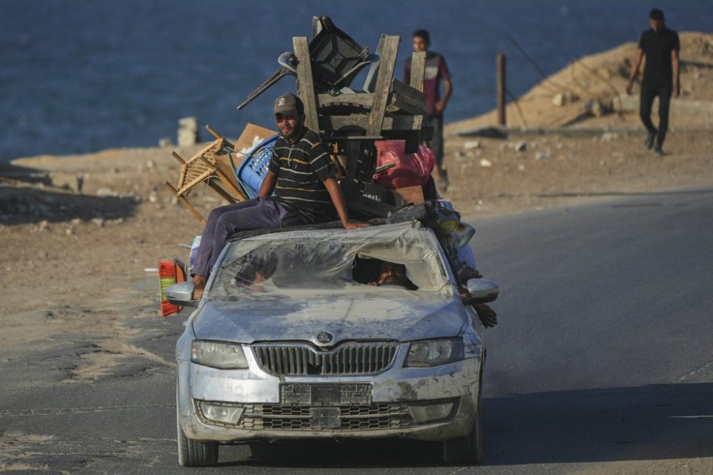 Displaced Palestinians fleeing northern Gaza carry their belongings in a car along the coastal road toward southern Gaza, Friday, Sept. 5, 2025. (AP Photo/Jehad Alshrafi)