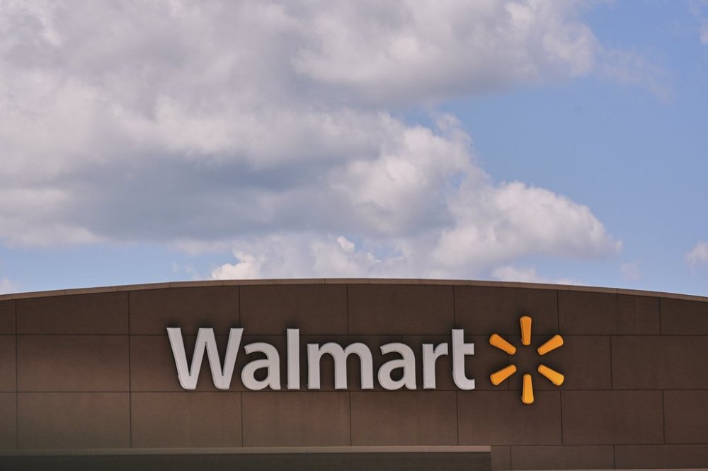 Clouds pass over the Walmart store, Thursday, Aug. 14, 2025, in Manchester, N.H. (AP Photo/Charles Krupa)