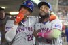 New York Mets' Juan Soto, left, celebrates with center fielder Starling Marte in the dugout after hitting a solo home run during the seventh inning of a baseball game against the Detroit Tigers, Tuesday, Sept. 2, 2025, in Detroit. (AP Photo/Ryan Sun)