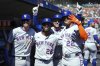 New York Mets' Juan Soto (22) celebrates his grand slam with Jeff McNeil (1), Cedric Mullins (28) and Luis Torrens (13) against the Detroit Tigers in the fourth inning during a baseball game Monday, Sept. 1, 2025, in Detroit. (AP Photo/Paul Sancya)