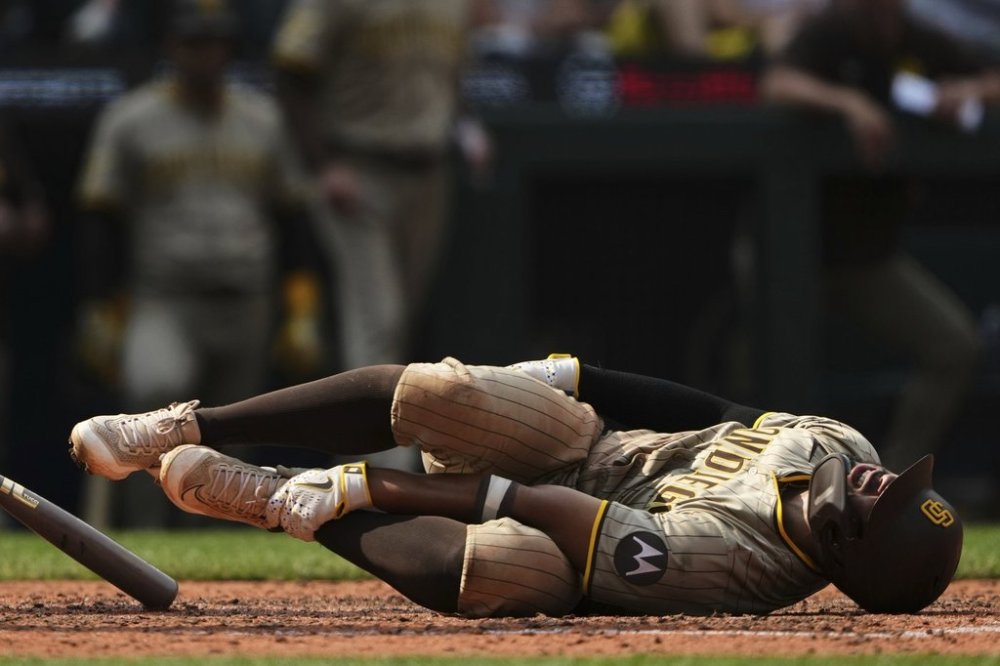 San Diego Padres' Xander Bogaerts reacts after fouling a ball off himself during the eighth inning of a baseball game against the Seattle Mariners, Wednesday, Aug. 27, 2025, in Seattle. (AP Photo/Lindsey Wasson)