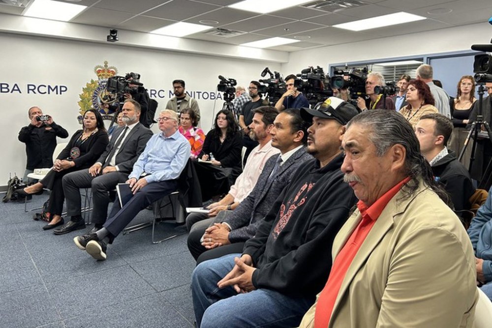 Hollow Water First Nation Chief Larry Barker, front right, and Manitoba Premier Wab Kinew, third right, attend a news conference at the RCMP regional headquarters in Winnipeg on Thursday Sept. 4, 2025. THE CANADIAN PRESS/Brittany Hobson