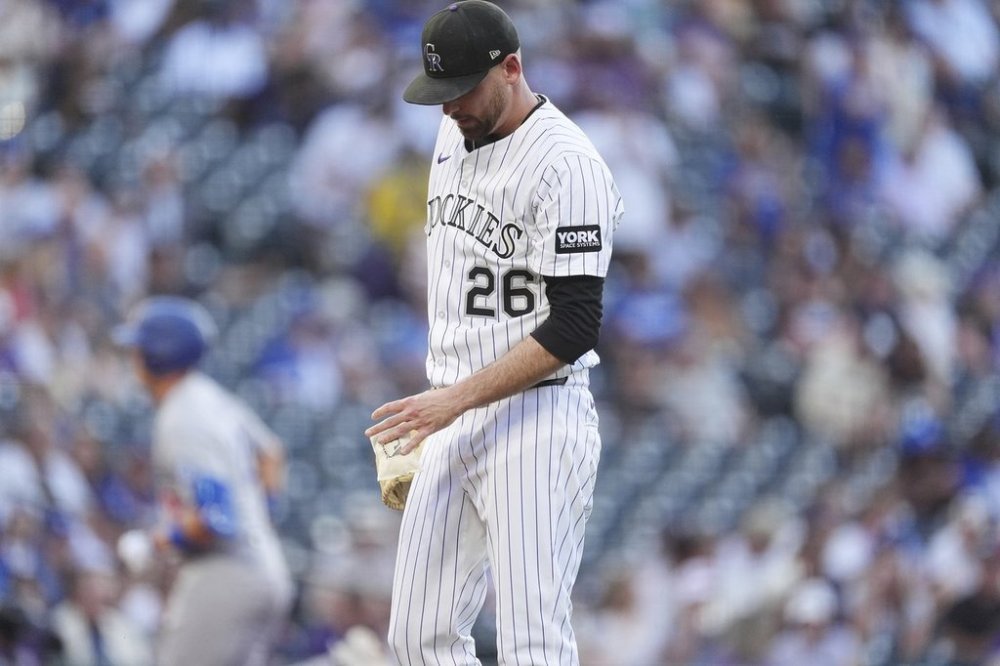Colorado Rockies starting pitcher Austin Gomber reacts after giving up a solo home run to Los Angeles Dodgers' Alex Call in the second inning of a baseball game Tuesday, Aug. 19, 2025, in Denver. (AP Photo/David Zalubowski)