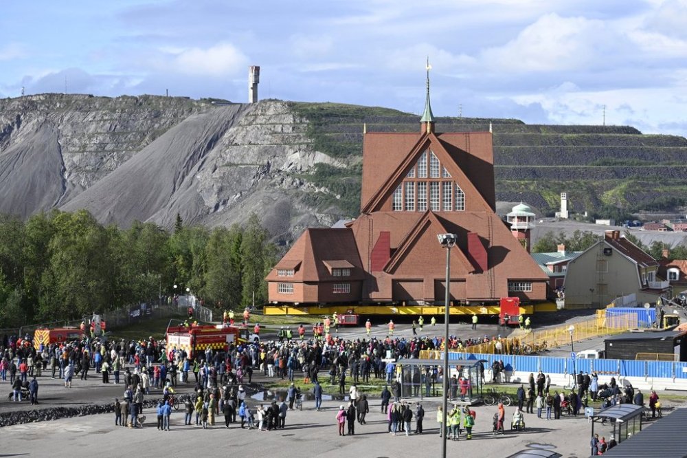 On a specially designed trolley with 224 wheels, Kiruna Church is being moved at a speed of half a kilometre per hour, in Kiruna, Sweden, Tuesday Aug. 19, 2025. (Fredrik Sandberg/TT News Agency via AP)